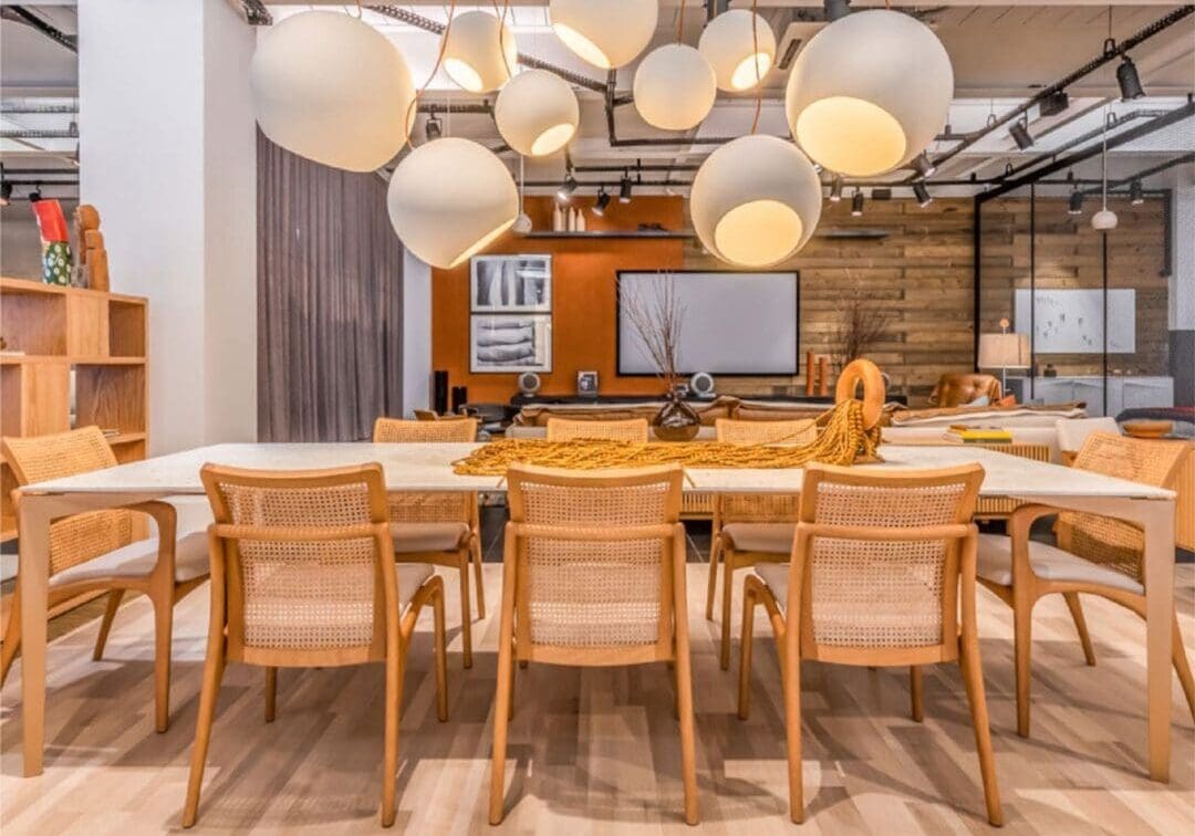 Modern conference room with wooden furniture and round hanging lights.