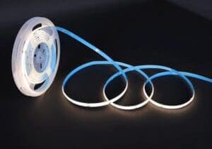 Glowing blue LED strip light coiled on a black surface.