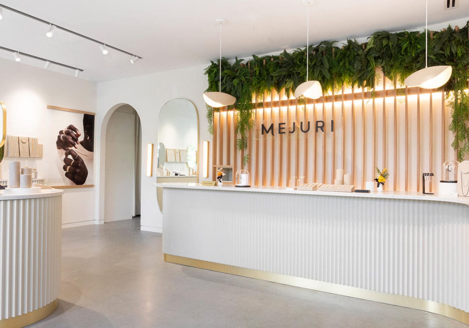 Modern reception area with stylish lighting and greenery.