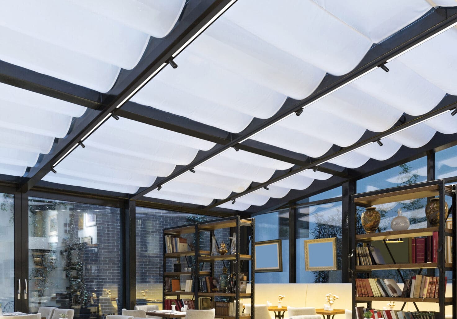 Modern indoor space with a translucent ceiling and shelves.