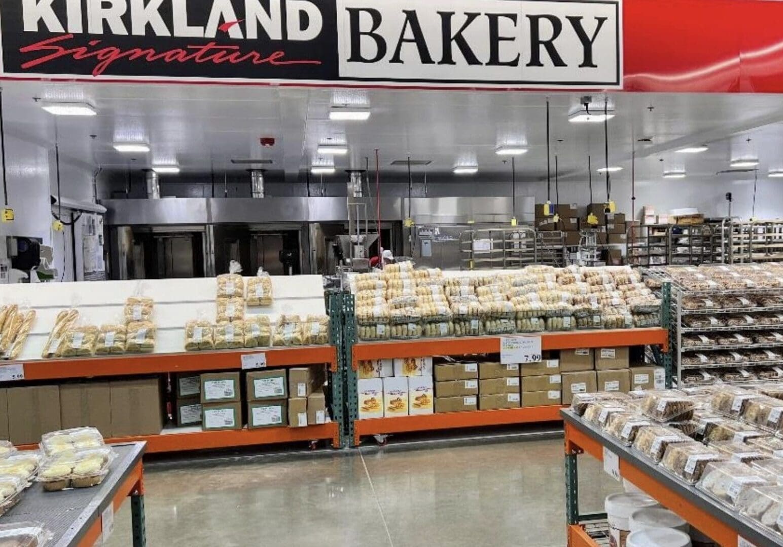 Bakery section with various breads and pastries on display at a Kirkland store.