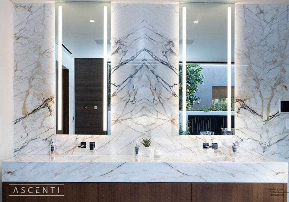 A bathroom with two sinks and three mirrors.