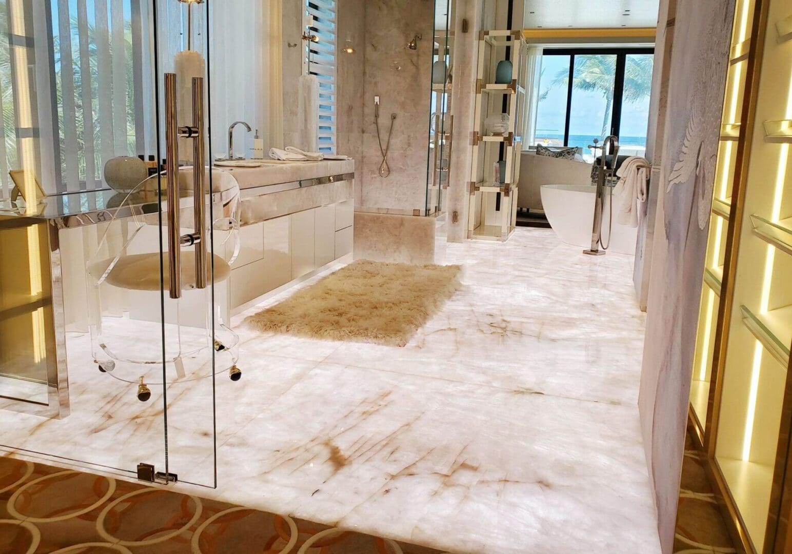 A bathroom with marble floors and walls.