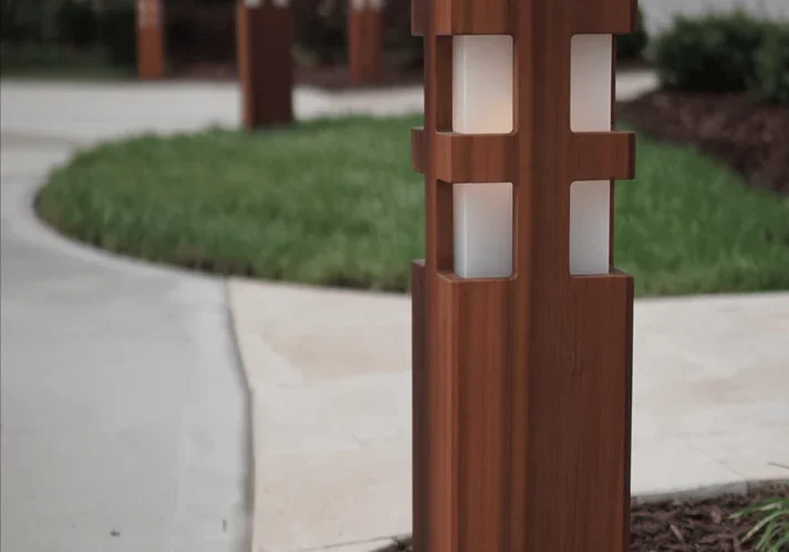 Modern wooden garden post lights along a pathway.