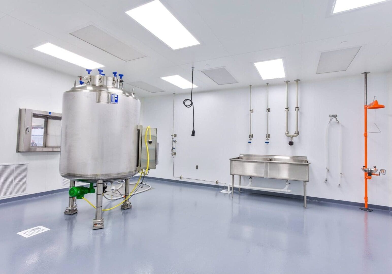 Clean, industrial room with stainless steel equipment and bright overhead lights.