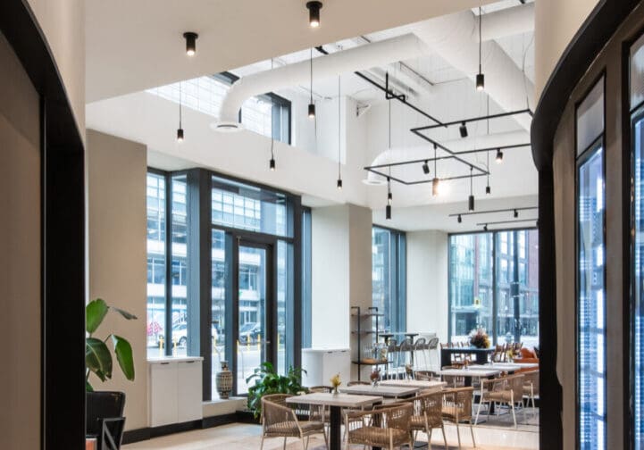 Modern office space with large windows and stylish furniture.