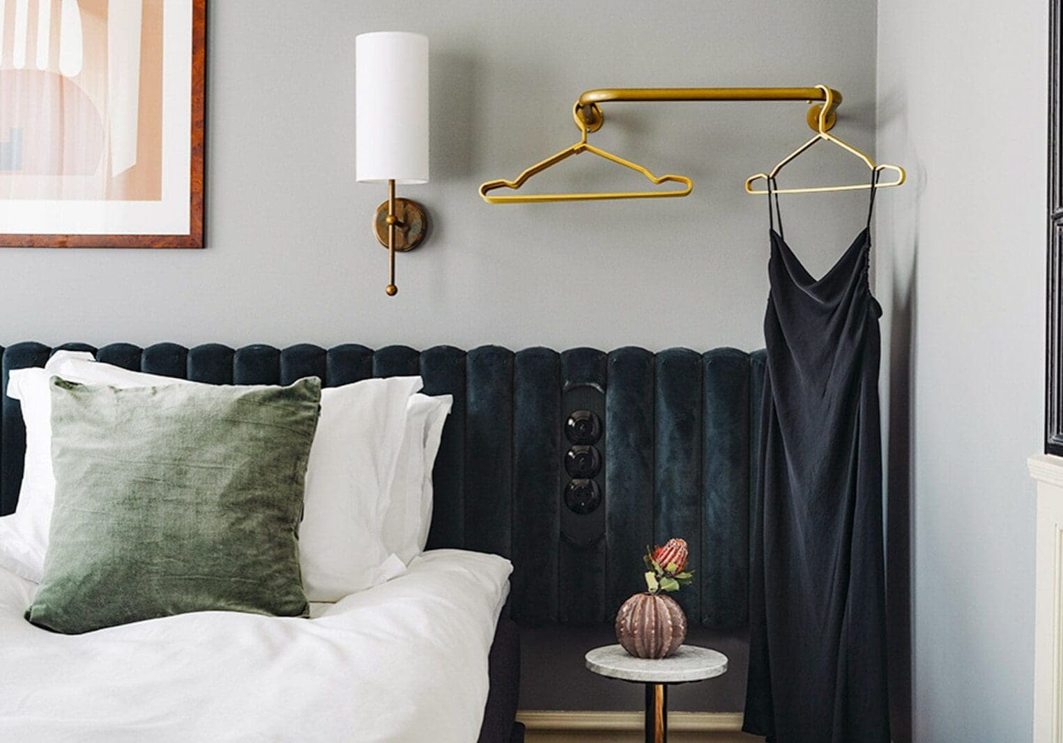 Elegant bedroom with a navy tufted headboard and gold accents.